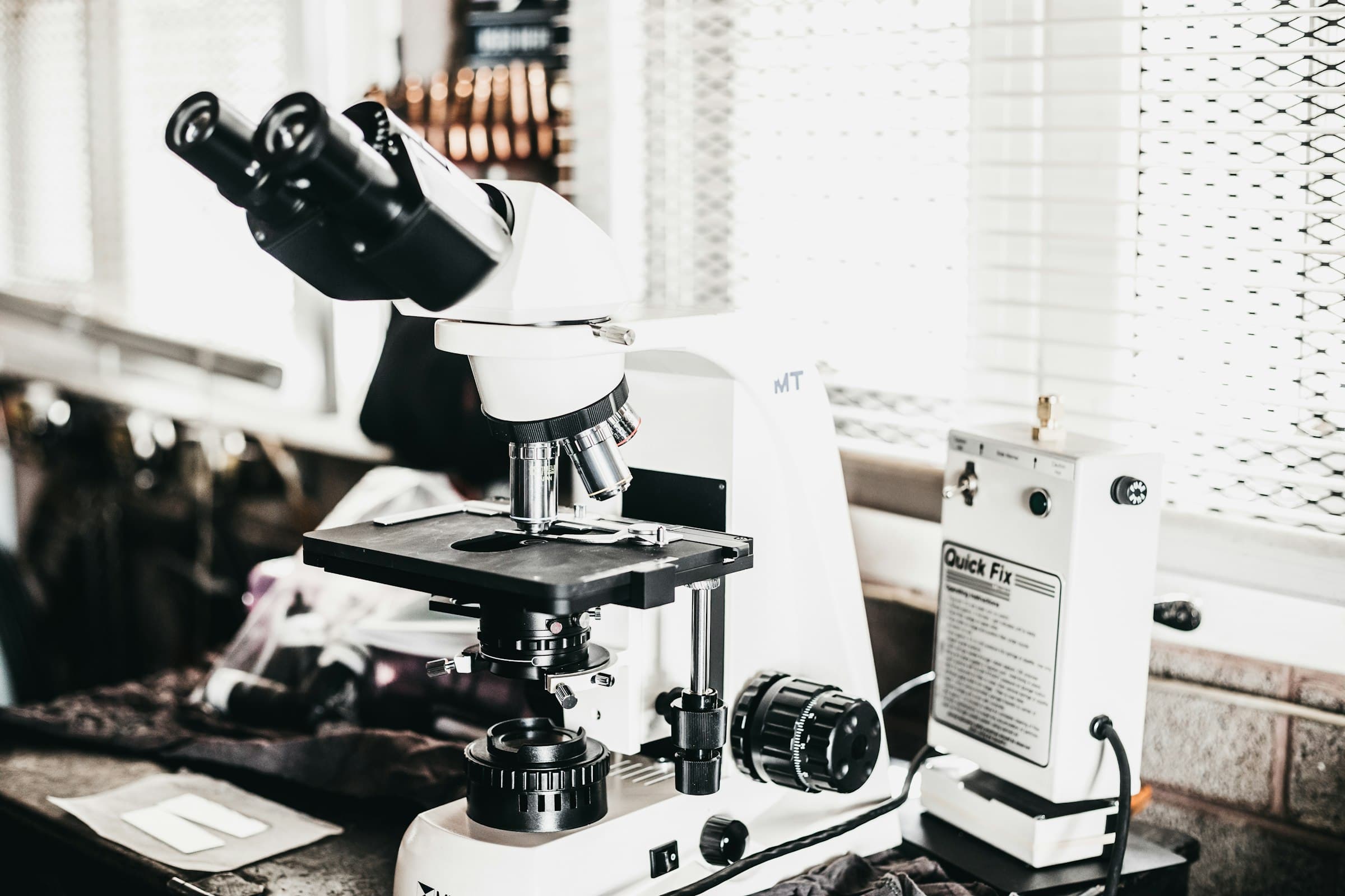 A laboratory microscope in black and white - precision healthcare